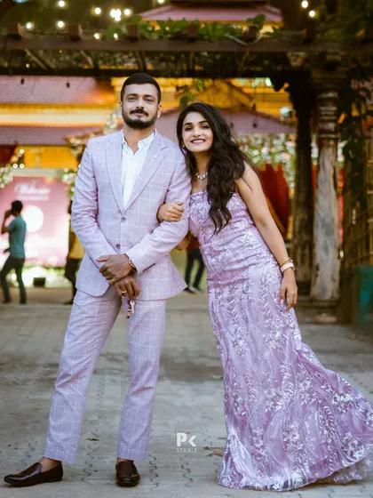 A playful and happy moment captured, with the couple looking stunning in their coordinated lavender outfits.