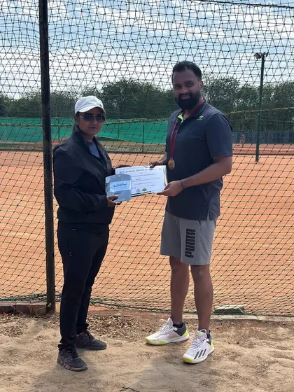 A coach awards a certificate to a semi finalist. We recognize and celebrate every stage of progress, encouraging players to keep pushing their boundaries.