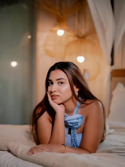A duplicate of image 267, this cozy and intimate portrait of a model on a bed has a warm and dreamy atmosphere.