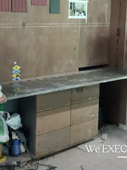 A behind-the-scenes shot of the bar area under construction, showing the raw materials and craftsmanship that go into creating the final polished piece.