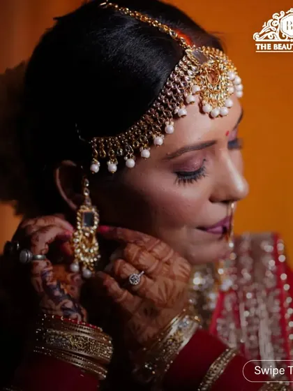 It's all in the details. This shot highlights the intricate eye makeup and how the jewellery, like the maang tikka and earrings, is integrated into the final look for a cohesive bridal style.