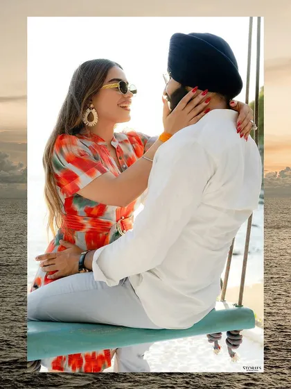 A creative shot framing a tender moment on a beach swing with the ocean, creating a dreamy, romantic feel.