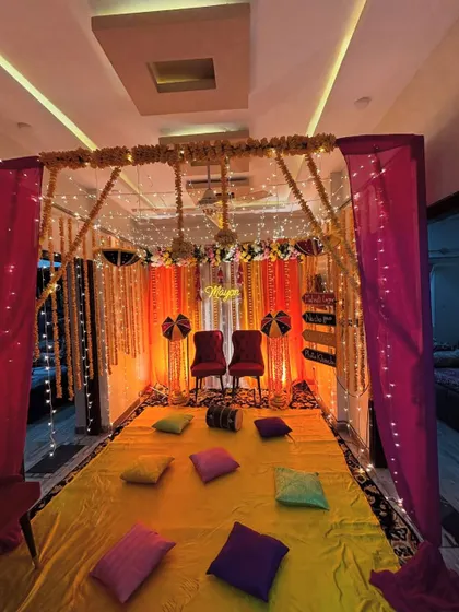 Another angle of the indoor Haldi setup, showing the floor seating arrangement with colorful pillows, perfect for a relaxed and traditional ceremony.