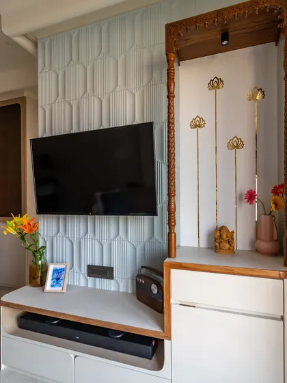 We seamlessly integrated a TV unit and a traditional temple space in this living room. The powder blue MDF panel adds a modern touch, while wooden pillars bring warmth.