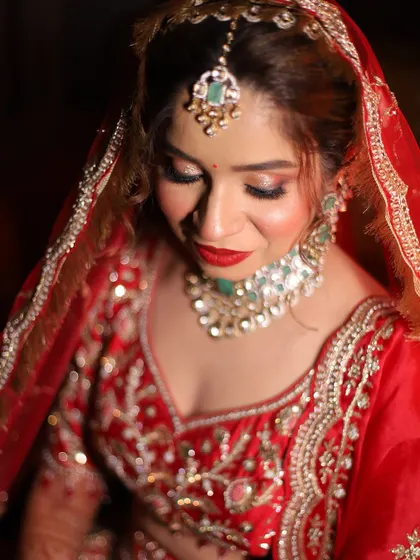 A close-up shot focusing on the glittery eye makeup and bold red lip. This combination is a classic for a reason, it's timelessly beautiful.