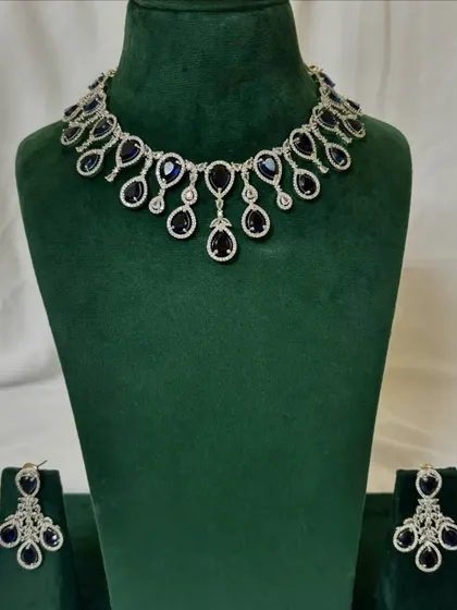 An American diamond necklace set with deep blue sapphire-like stones. This rental piece is perfect for adding a pop of colour to your evening wear.