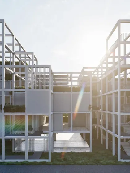 The sun flares over the modular structure of Pixel Housing, highlighting its skeletal frame and the potential for green infill.