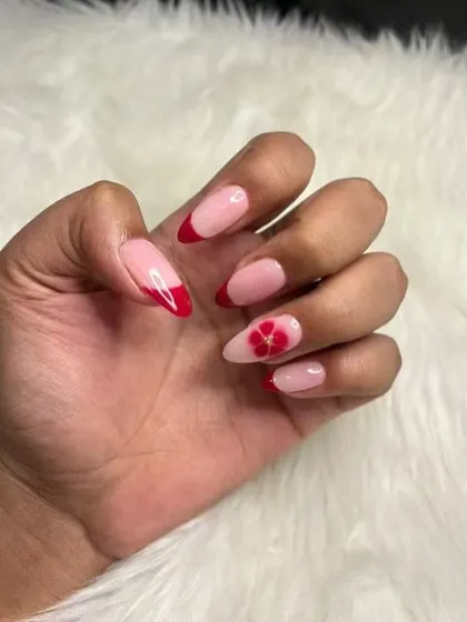 A romantic take on the French manicure, with red tips and a beautiful blooming flower accent nail.
