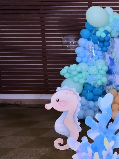 A close-up of a cute seahorse cutout, one of the many custom props used to create the underwater atmosphere.