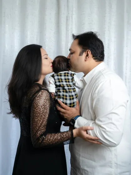 Sealed with a kiss from mommy and daddy. This is the purest form of love, all in one frame.