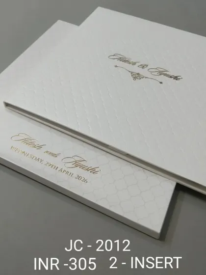 This hardcover invitation features a clean white quilted pattern and elegant gold script. It's a simple yet luxurious choice for a modern, formal wedding.