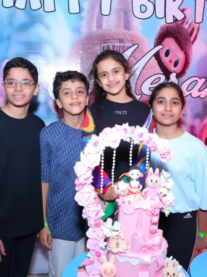 The birthday girl and her friends pose with the beautiful Labubu-themed cake. It's a unique and trendy theme that we can execute perfectly.