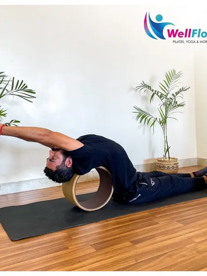 Another view of the yoga wheel in action, showing how it can be used to achieve a deep, restorative stretch for the entire front of the body.