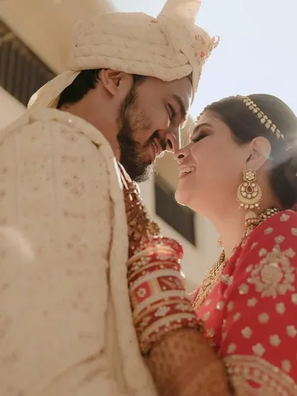 A close-up shot capturing the intimacy and happiness between a couple, their faces close together, basking in the sunlight and their love.