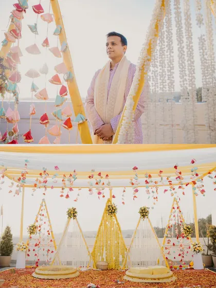 A two-panel shot showcasing the groom and the stunning haldi decor. The yellow and white theme with floral details created a beautiful and serene setting for the ceremony.