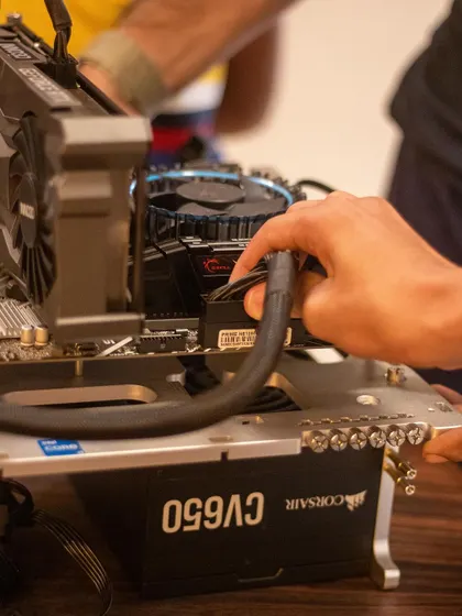 Connecting the main power supply to the motherboard. Students learn the importance of a stable power source and how to safely handle all the connections.