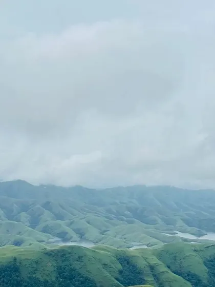 A panoramic view of the rolling hills and Lakya Dam backwaters from the Gangadikal trek.