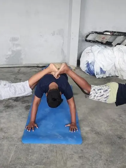 This unique three-person pose requires a strong base and great balance from the two flyers.