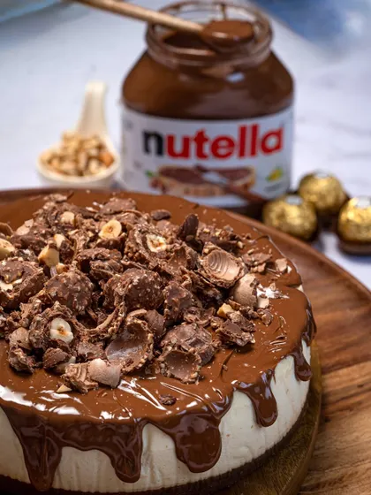 My Ferrero Rocher Nutella Cheesecake, with a jar of Nutella in the background to show you I mean business. It's a creamy, dreamy, decadent delight.