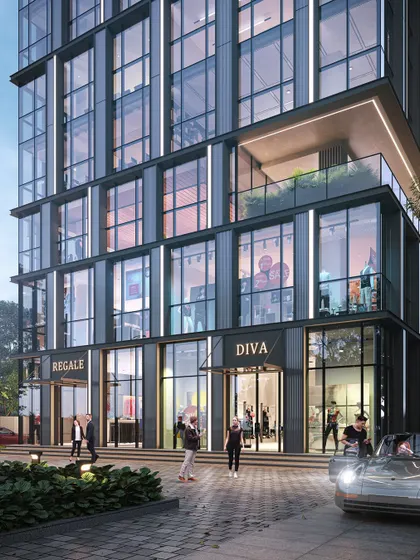 A street-level view of the "Diva" commercial building in Surat. The design features a transparent ground floor to invite the public in, while the upper floors maintain a sleek, minimalist aesthetic inspired by the precision of a cut diamond.