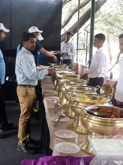Guests lining up at our buffet during a sports day event. We can cater to all types of outdoor gatherings, ensuring everyone gets a hearty and delicious meal.