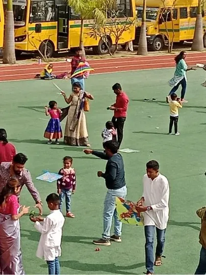 Parents and children work together to get their kites airborne, a perfect example of family bonding and teamwork.