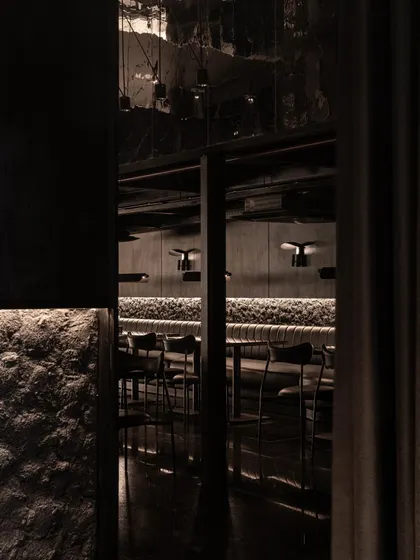 A collection of atmospheric shots from Lair, showcasing the interplay of black concrete, glass blocks, polished steel, and dramatic lighting. Each image captures a fragment of the bar's mysterious and immersive character.