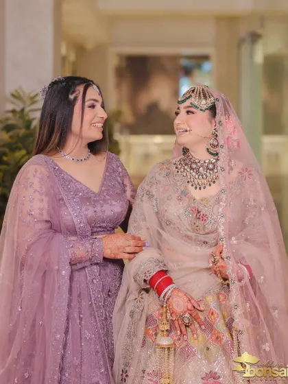 A sweet moment between the bride and her sister or friend, sharing a smile on the wedding day.