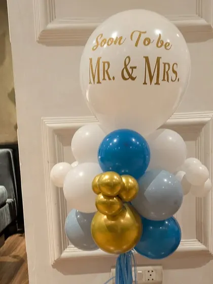 A clear shot of the custom balloon arrangement for an engagement celebration, featuring a personalized balloon and a stylish color scheme.