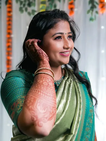 A bride shows off her intricate mehndi design in this lovely portrait.