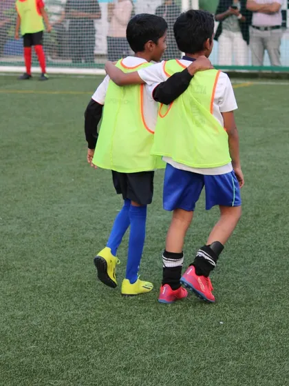 An arm around a teammate's shoulder shows the bond that forms when playing together as part of the Sportonix FC family.