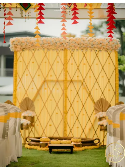 A wider view of the elegant yellow-themed Haldi stage, ready for the ceremony.