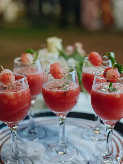 Fresh watermelon mocktails, garnished with melon balls and mint. These drinks are not only delicious but also beautifully presented, enhancing the overall guest experience.