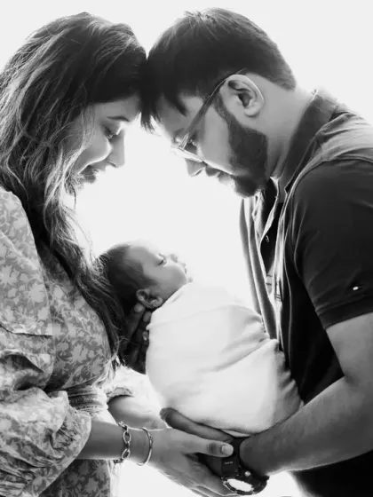 A black and white version of the new family portrait. This treatment adds a timeless, classic feel, focusing on the light, emotion, and the beautiful connection between the three of them.