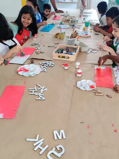 A lively shot of children painting and decorating their own custom nameplates during a birthday celebration. It's a fantastic hands-on activity for a group.