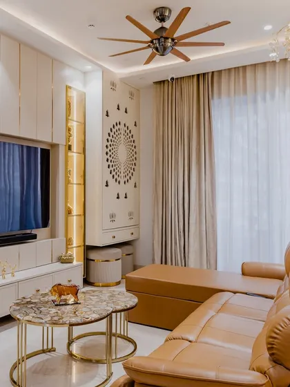 This living and entertainment area is designed for comfort and style. The plush leather recliner is perfect for movie nights, while the custom TV unit includes a dedicated pooja space, seamlessly integrating tradition with modern design.
