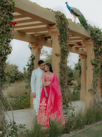 A perfect moment at Suryagarh, Jaisalmer, where a peacock decided to join Kajal and Ram's couple shoot. This unplanned guest added a touch of royal Rajasthani charm to their romantic portrait.