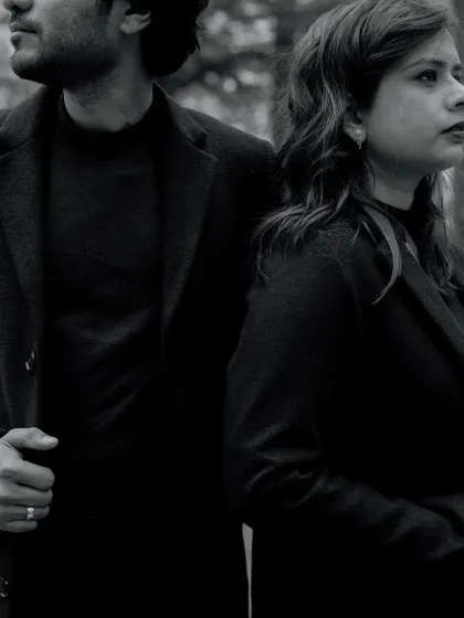 A moody black and white portrait of a couple in the Manali forest. The serious expressions and dark tones create a dramatic and cinematic feel.