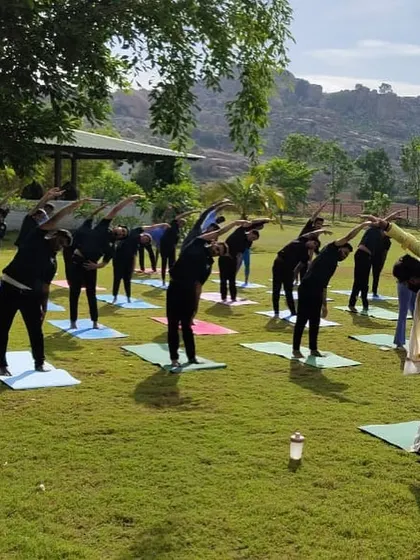 A side view of our International Yoga Day celebration. The lush green lawn provides a natural, comfortable yoga mat for our guests to practice on.