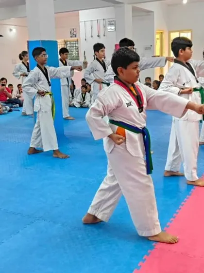 Students practicing a middle punch during their forms.