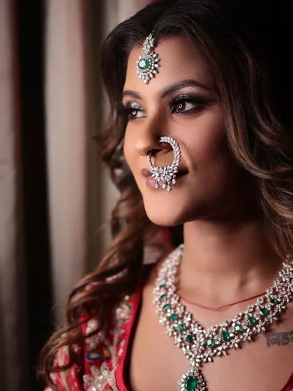 A stunning portrait of my bride, radiant in red. Her look is completed with a beautiful diamond nath and emerald jewellery.