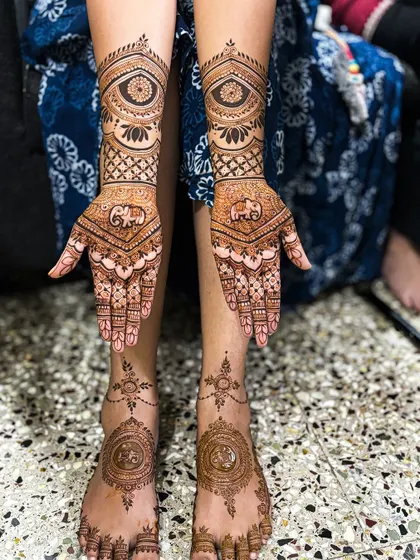 A full view of Nayana's bridal mehendi, combining hand and feet designs in one beautiful shot.
