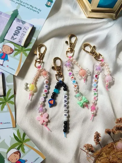 A detailed look at the custom beaded name keychains we created for our Eid collection, featuring charms like butterflies and superheroes.