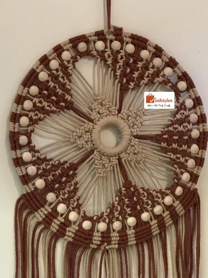 A close-up of the center of the dreamcatcher, showing the star-like floral pattern. Every knot is tied with care and precision.