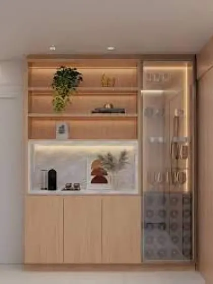 A compact and stylish coffee and bar nook. The design features back-lit shelves, a built-in wine rack, and cabinets, all in a beautiful light wood finish.