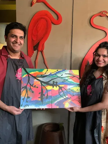 Another happy couple with their completed joint canvas painting. It's a beautiful symbol of partnership and a fun, creative way to spend time together.