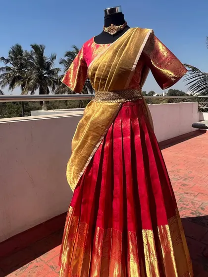 A full view of the beautiful red and gold half saree.