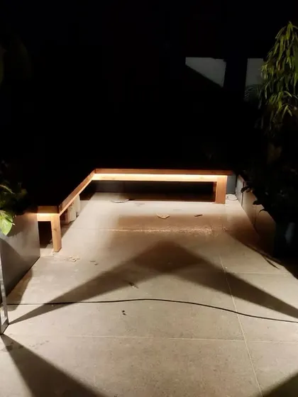 Outdoor lighting is an art. In this rooftop garden, I played with light and shadows, using modern fixtures to cast dramatic, symmetrical patterns on the ground, creating a magical effect.