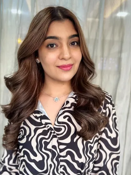 Cozy up to the rich tones of the season. This client's hair is a beautiful blend of browns, styled in soft, glamorous waves.