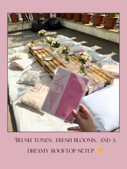 Blush tones, fresh blooms, and a dreamy rooftop setup. This image highlights the custom menu card against the backdrop of the beautifully styled picnic table.